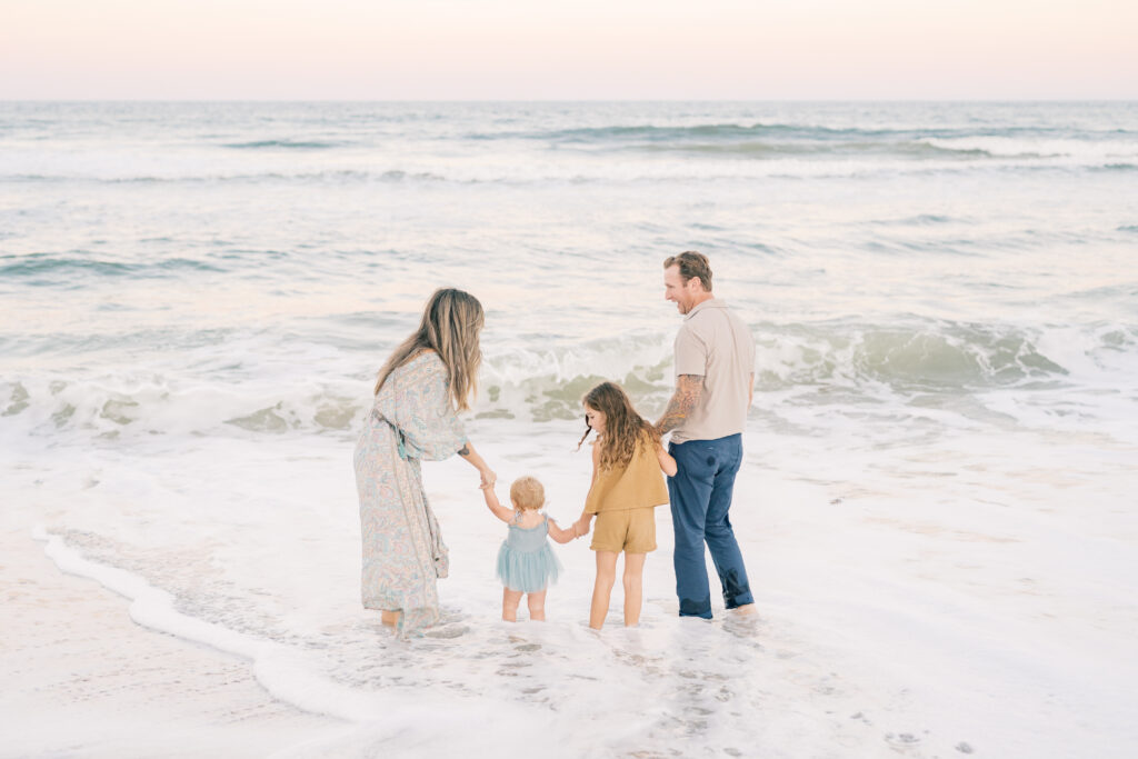 Family of four standing in water at Guana Reserve Middle Beach Jacksonville FL